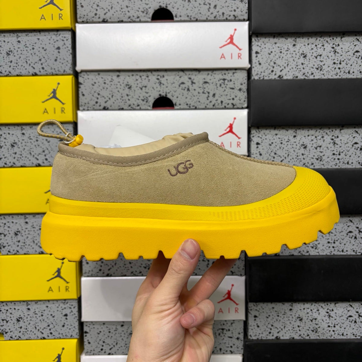 UGG Neumeel Deco Slip-On – Suede Moccasin Sneaker with Yellow Lug Sole & Carabiner Collar in Sand